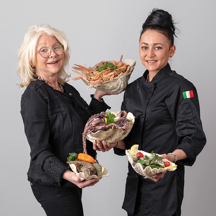 Sophie-mare-Photographe-seingbouse-portrait-corporate-professionel-profil-cv-linkedin-site-internet-23 2 femmes restauratrices, en tenues noires et drapeau italien, avec des coquillages remplis de crustacés